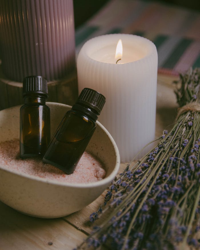 Close-up of essential oils, candles, and lavender for a calming spa ambiance.